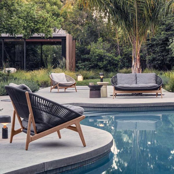 Image of Gloster Bora modern garden lounge furniture around serpentine form of poolside