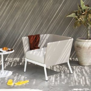 Image of Calla contemporary outdoor relax chair together with Button circular side table by RODA Italy.