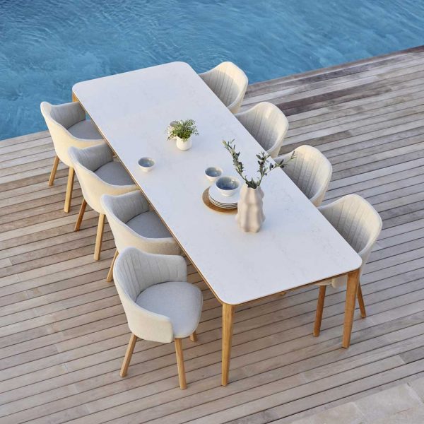 Image of aerial view of Aspect modern teak garden table and Choice sustainable garden chairs by Cane-line on poolside