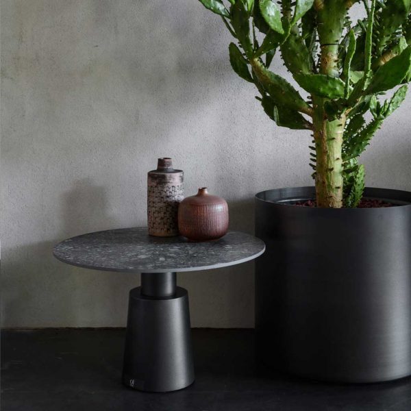 Image of dark grey Drums geometric exterior low table next to OiPots contemporary planter by Oiside