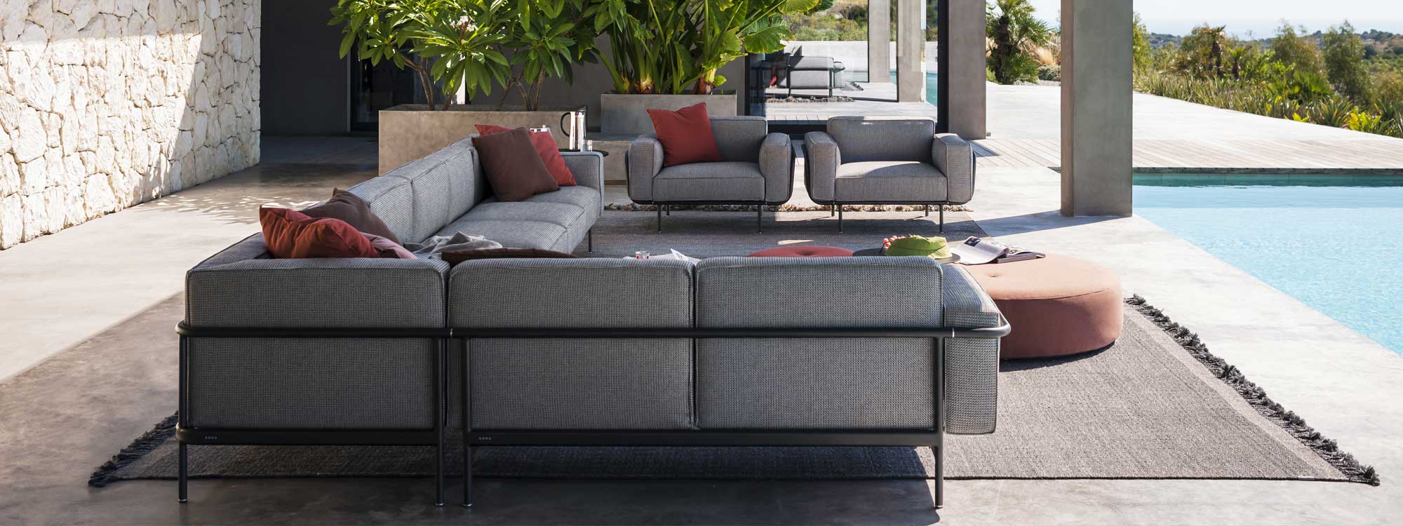 Image from rear of RODA Estendo modern garden corner sofa, showing the furniture's elegant tubular black aluminium frame