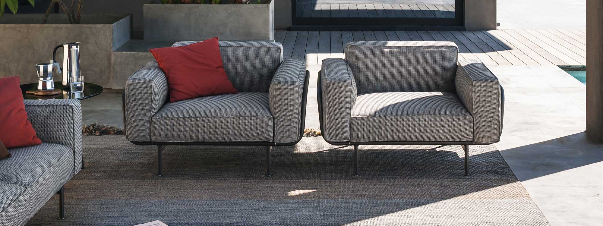Image of pair of RODA Estendo linear garden lounge chairs on shady courtyard