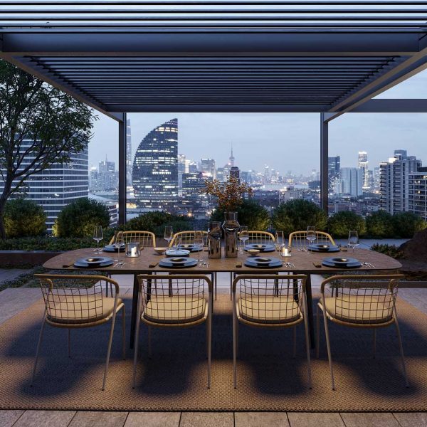 Image of Styletto modern garden dining table and Fensi outdoor chairs by Royal Botania on city rooftop terrace at dusk