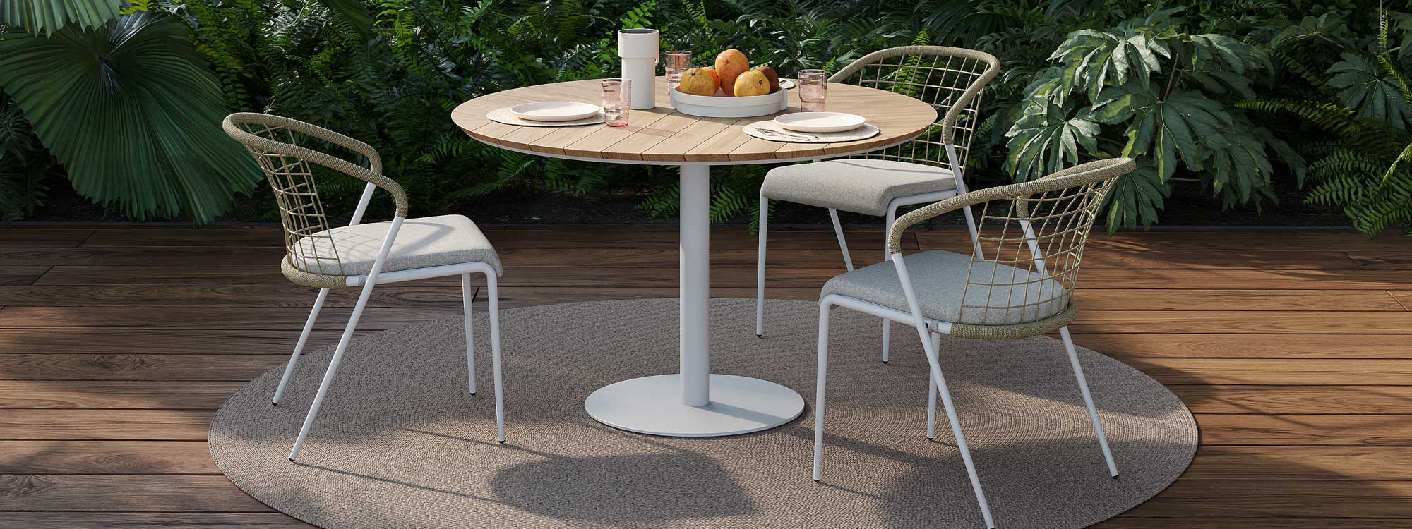Image of Butler round garden table with white base and teak top and Fensi modern garden chairs by Royal Botania
