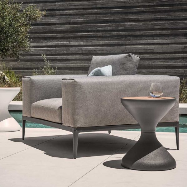 Image of Grid minimalist garden lounge chair and Bells hourglass-shaped side table by Gloster