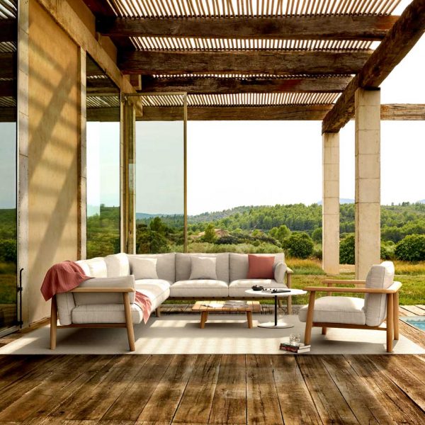 Image of Royal Botania Mambo Lounge contemporary teak corner sofa on terrace beneath cane pergola roof