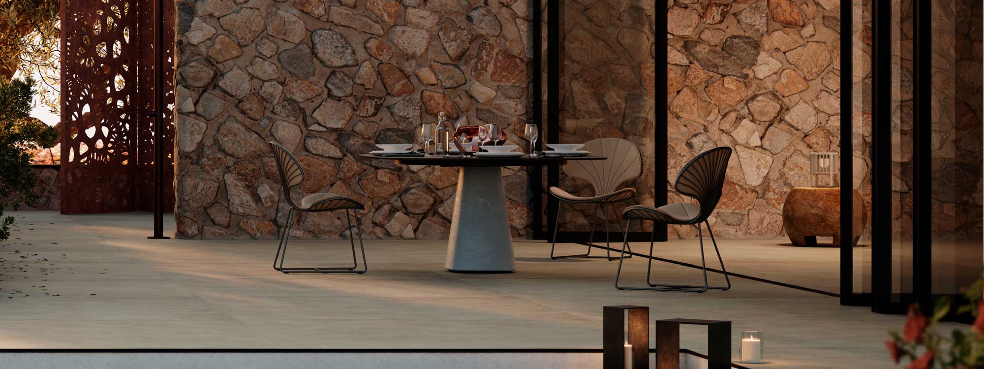 Image of Royal Botania Conix pedestal table with Ostrea modern garden chairs on tranquil courtyard