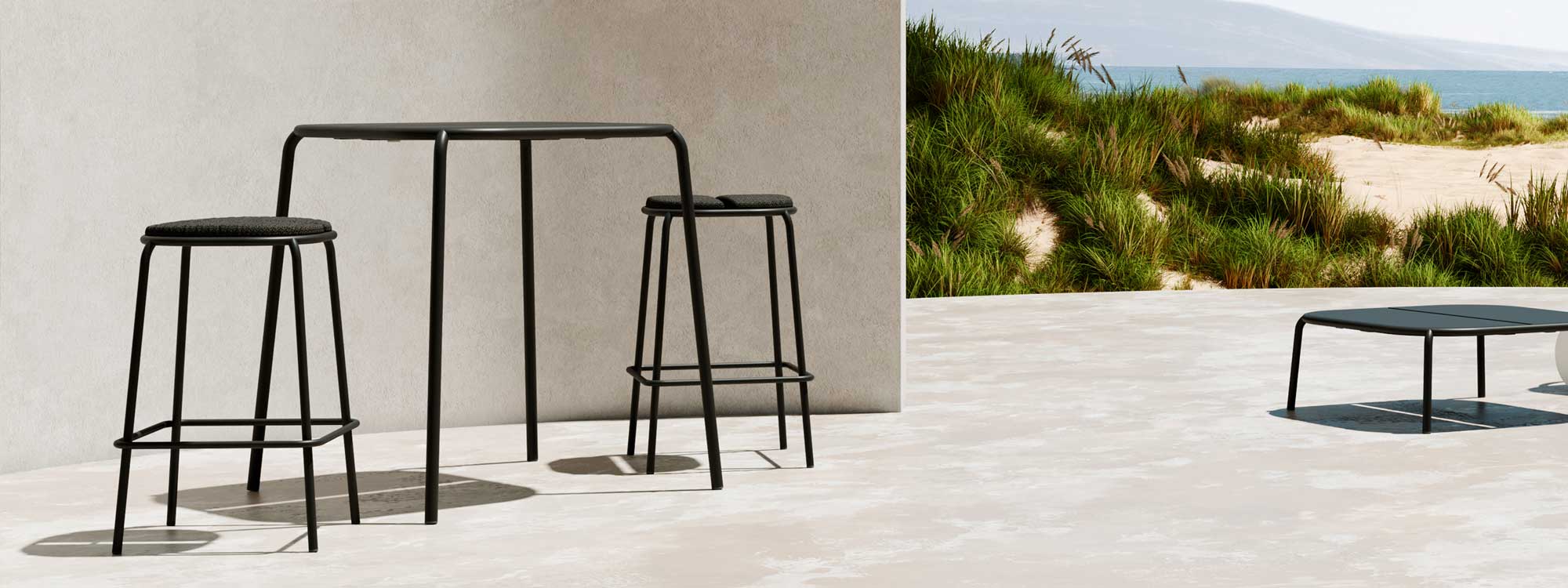 Image of Oiside Parc stacking poseur table and bar stools on sunny terrace with sand dunes and sea in the background