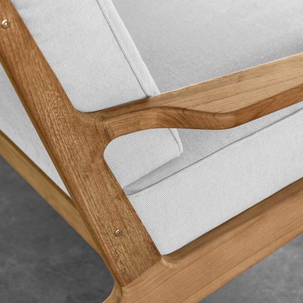 Image of detail of Gloster Bay's teak joinery and luxurious white garden cushions