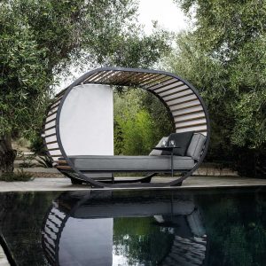 Image of Gloster Cradle Lounge daybed next to water feature