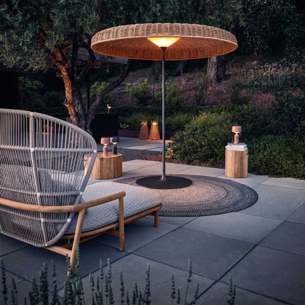 Image of Gloster Fern modern garden daybed and Ambient Sol garden light at dusk