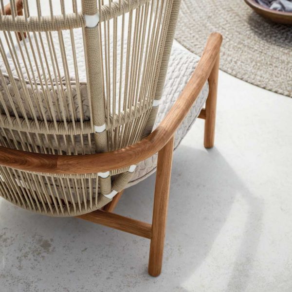 Image of detail of Fern lounge chair's Dune-coloured all-weather rope back and teak frame by Gloster