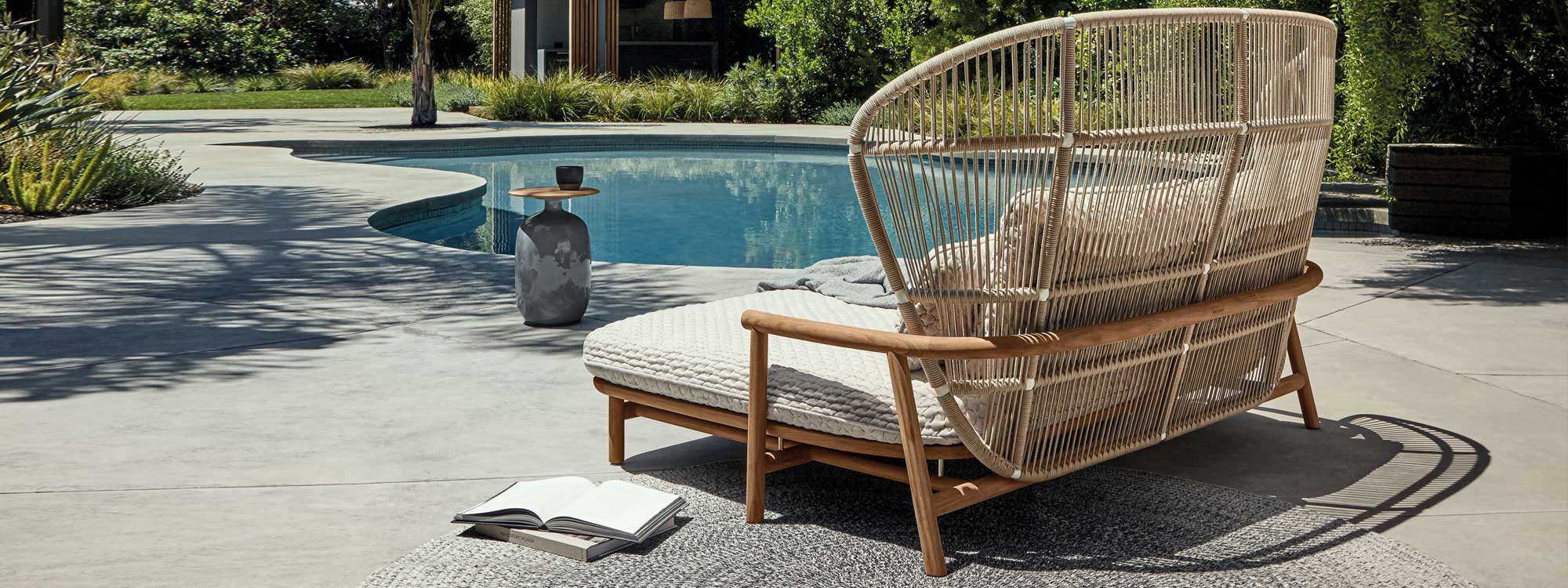 Image of Gloster Fern contemporary garden daybed with Blow low table next to sunny swimming pool