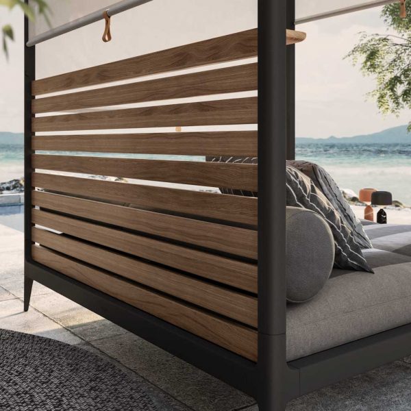 Image of detail of rear of Grid Cabana daybed's slatted teak back and Meteor-grey aluminium frame by Gloster