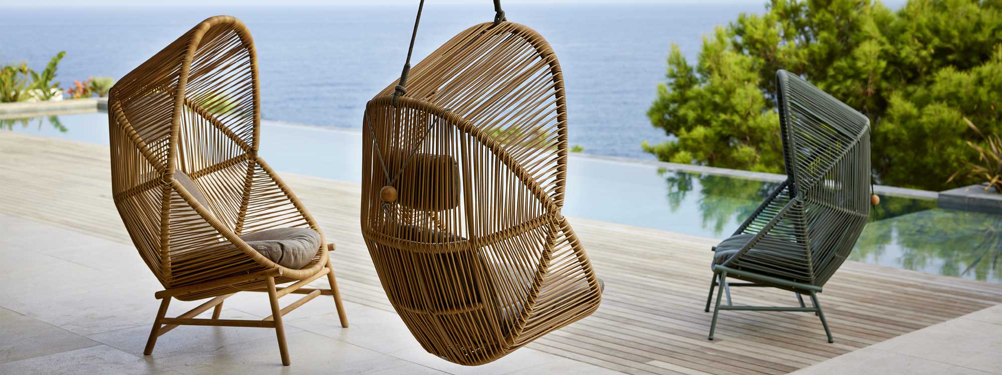 Image of Cane-line Hive high-backed lounge chairs in Cane-line Weave together with Hive hanging garden chair