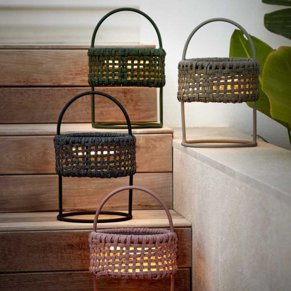 Image of Illusion freestanding solar garden lanterns in different colours by Cane-line, on flight of stairs