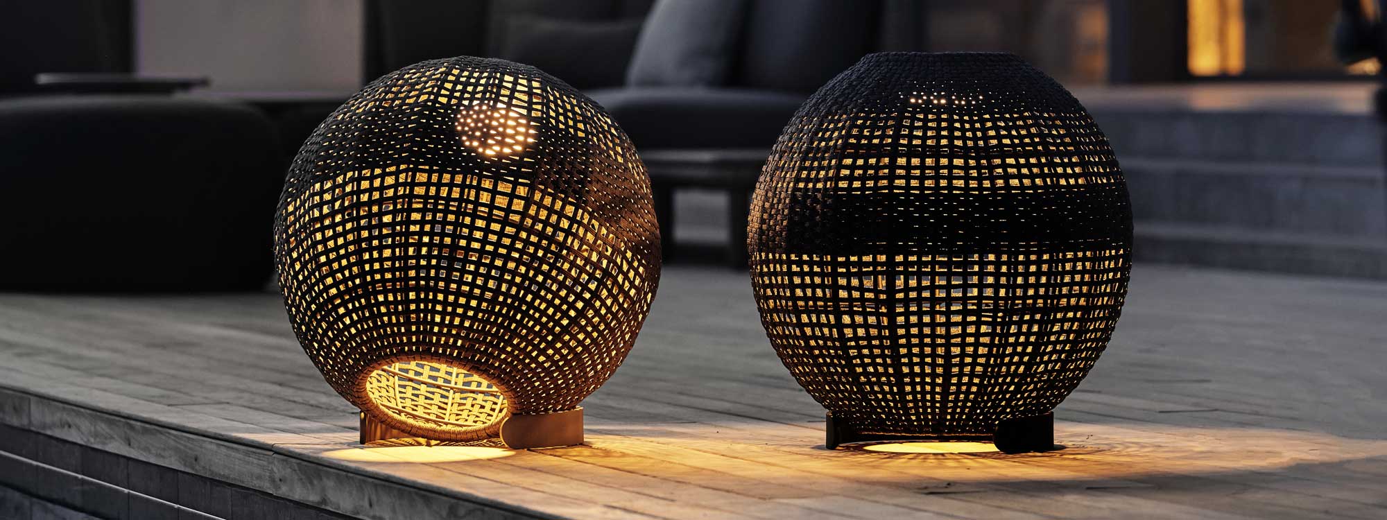 Image of pair of illuminated Illusion spherical solar lanterns by Cane-line