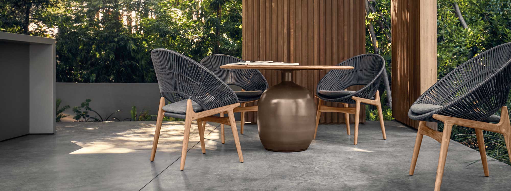 Image of Kasha glazed ceramic garden table and Bora dining chairs by Gloster