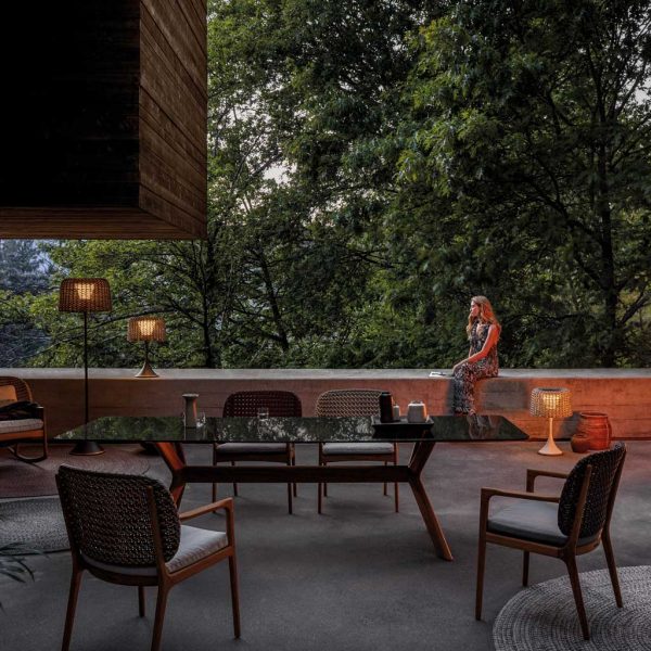 Image at dusk of Gloster Kay garden dining furniture on terrace