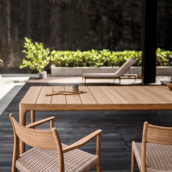 Image of Gloster Lima teak garden table and dining chairs with hand-woven all-weather wicker seats