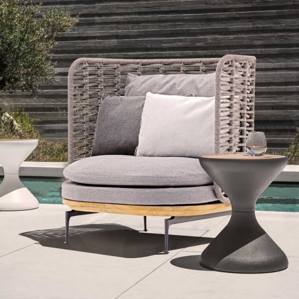 Image of Gloster Mistral outdoor lounge chair and Bells modern side table on sunny terrace