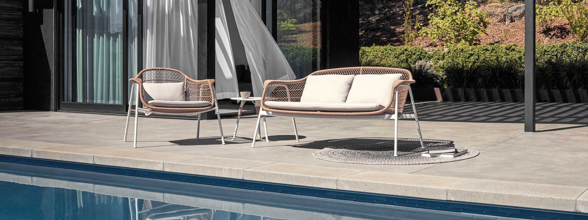Image of Gloster Fresco retro garden sofa and lounge chair in white tubular aluminium and Wheat coloured all-weather wicker