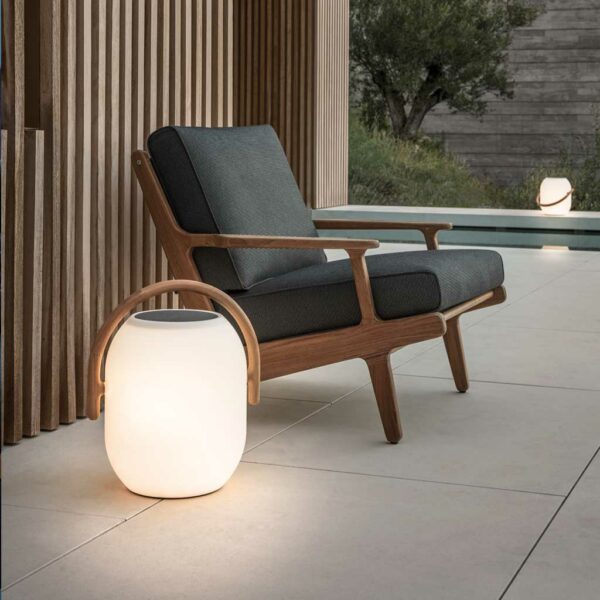 Image of Ambient Cocoon modern outdoor lantern next to Gloster Bay lounge chair