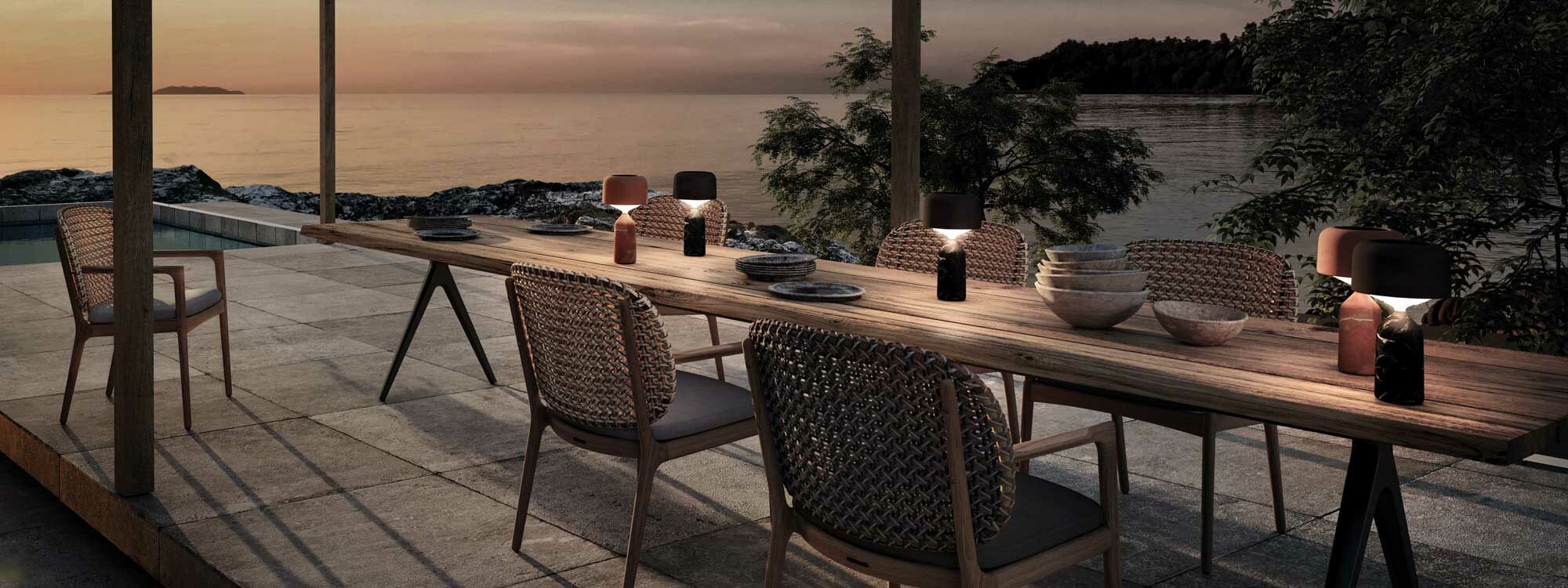 Image of Pebble modern outdoor table lamps on Raw table by Gloster at dusk