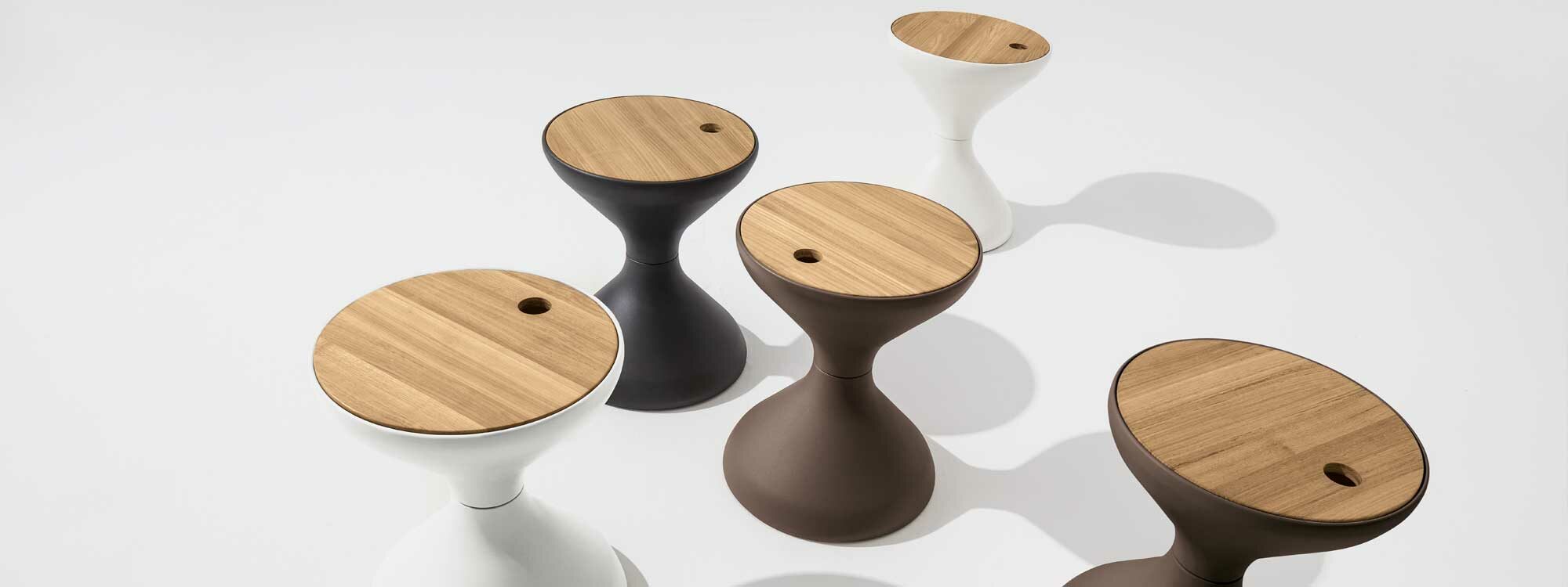 Studio image of several Bells garden side tables and ice buckets by Gloster garden furniture