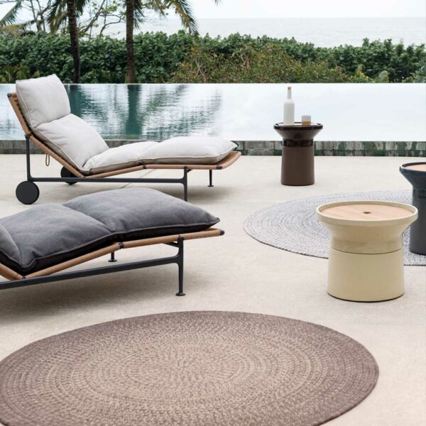 Image of Gloster Coso ceramic low tables and side tables together with Zenith sun loungers on stylish poolside