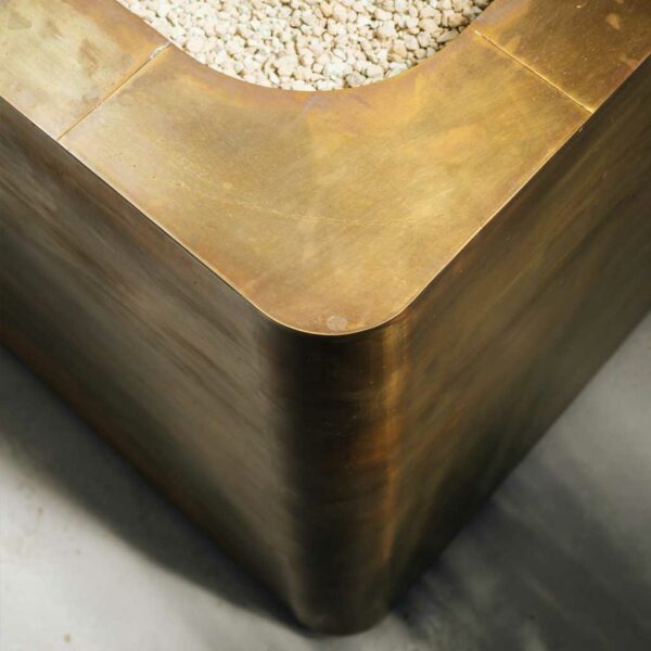 Image of detail of the corner of Cupum cube brass planter