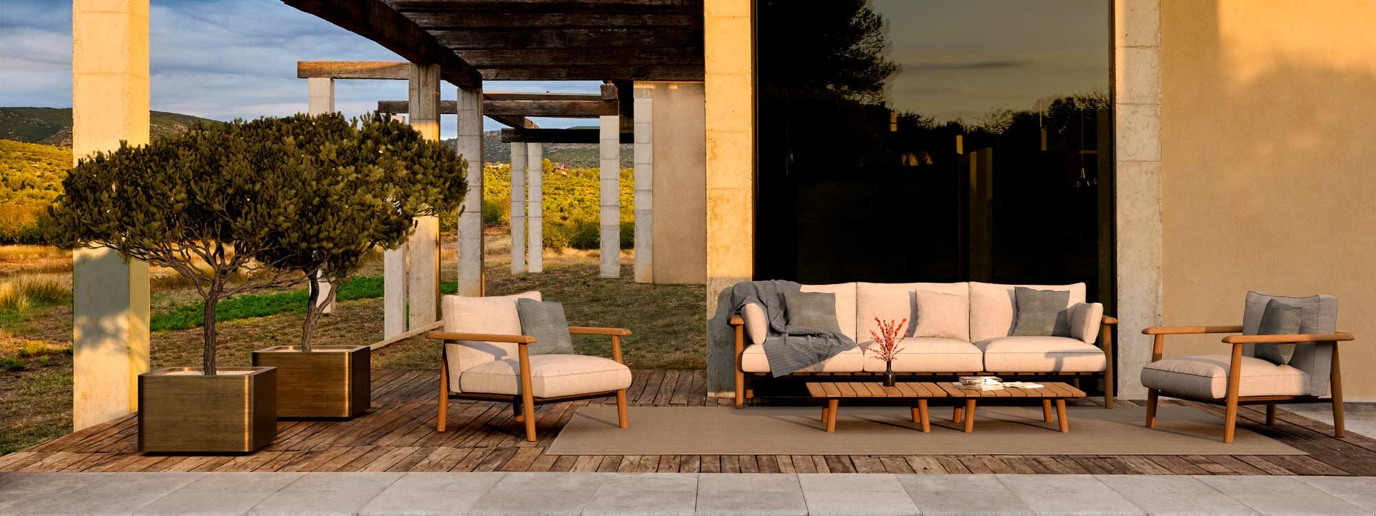 Image of Royal Botania Mambo Lounge teak sofa and Cuprum square brass planters on sunny terrace