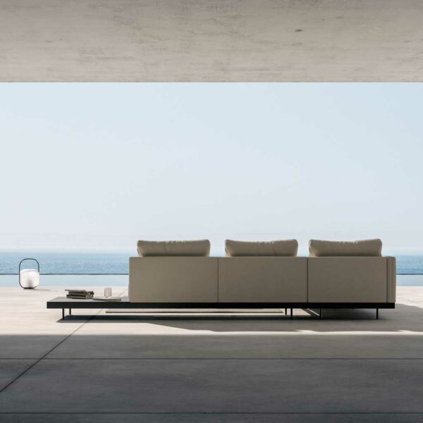 Image of rear of Dongo modern modular garden sofa by Todus, with blue sea and sky in the background
