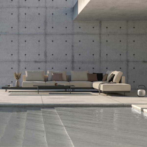 Image of Dongo contemporary garden sofa by Todus on poolside, with brutalist concrete architecture in the background
