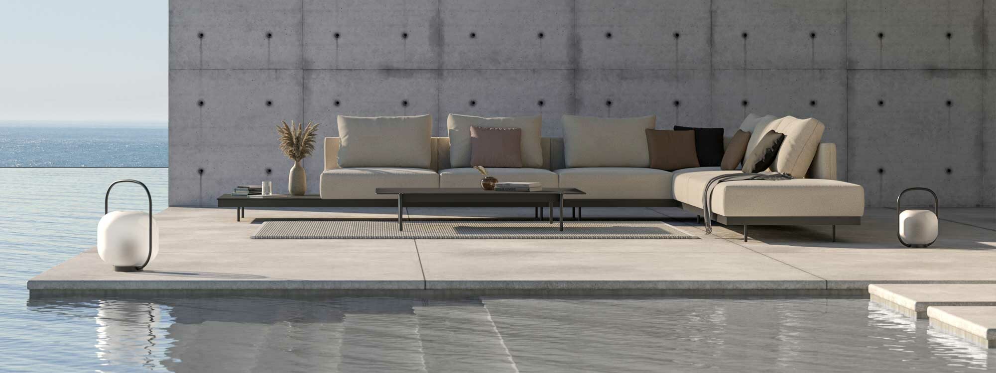 Image of Todus Dongo minimalist garden sofa on concrete balcony, with brutalist architecture and sea in the background