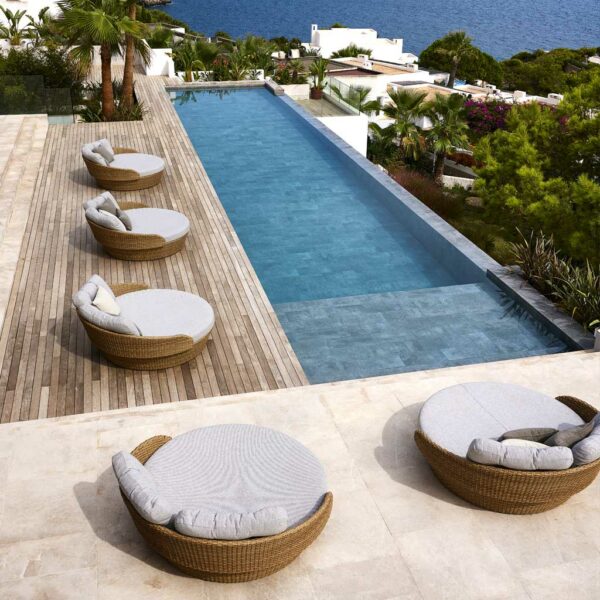 Image of 5 Cane-line Ocean luxury rattan daybeds by Cane-line around long rectangular swimming pool