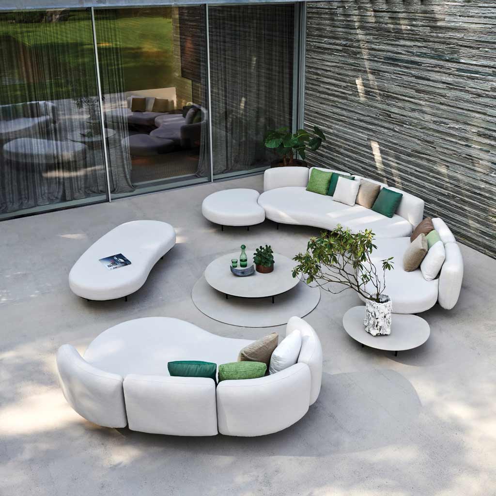 Birdseye image of Organix contemporary garden sofas with a slate feature wall behind and glass sliding doors