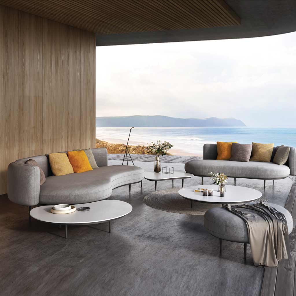 Image of Organix contemporary outdoor sofas and low tables within a modernist pergola, with beach, sea and sky in the background