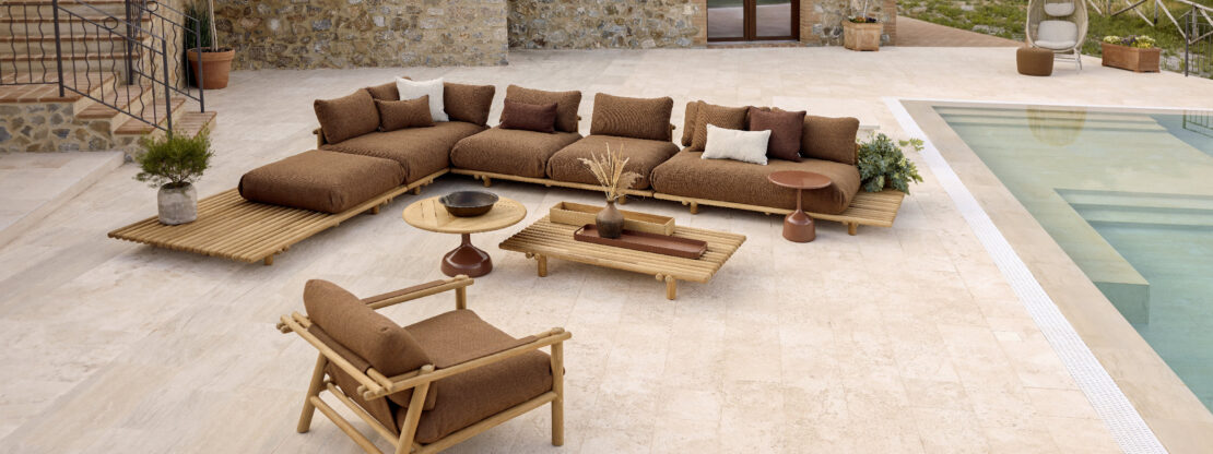 Image of Cane-line Sticks Platform modern teak garden sofa on sunny courtyard