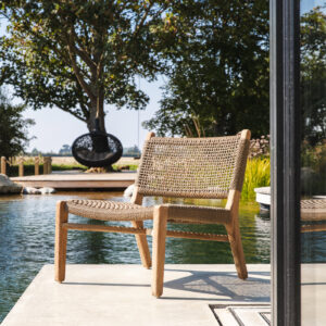 Image of Gommaire Fiona easy chair on concrete deck next to natural swimming pool at the Watershed Bosham