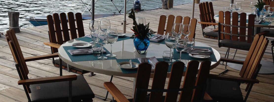 Image of Grythyttan A2 Cantilever Chair teak and galvanised garden furniture at Custard Apple restaurant, English Harbour, Antigua - Caribbean.