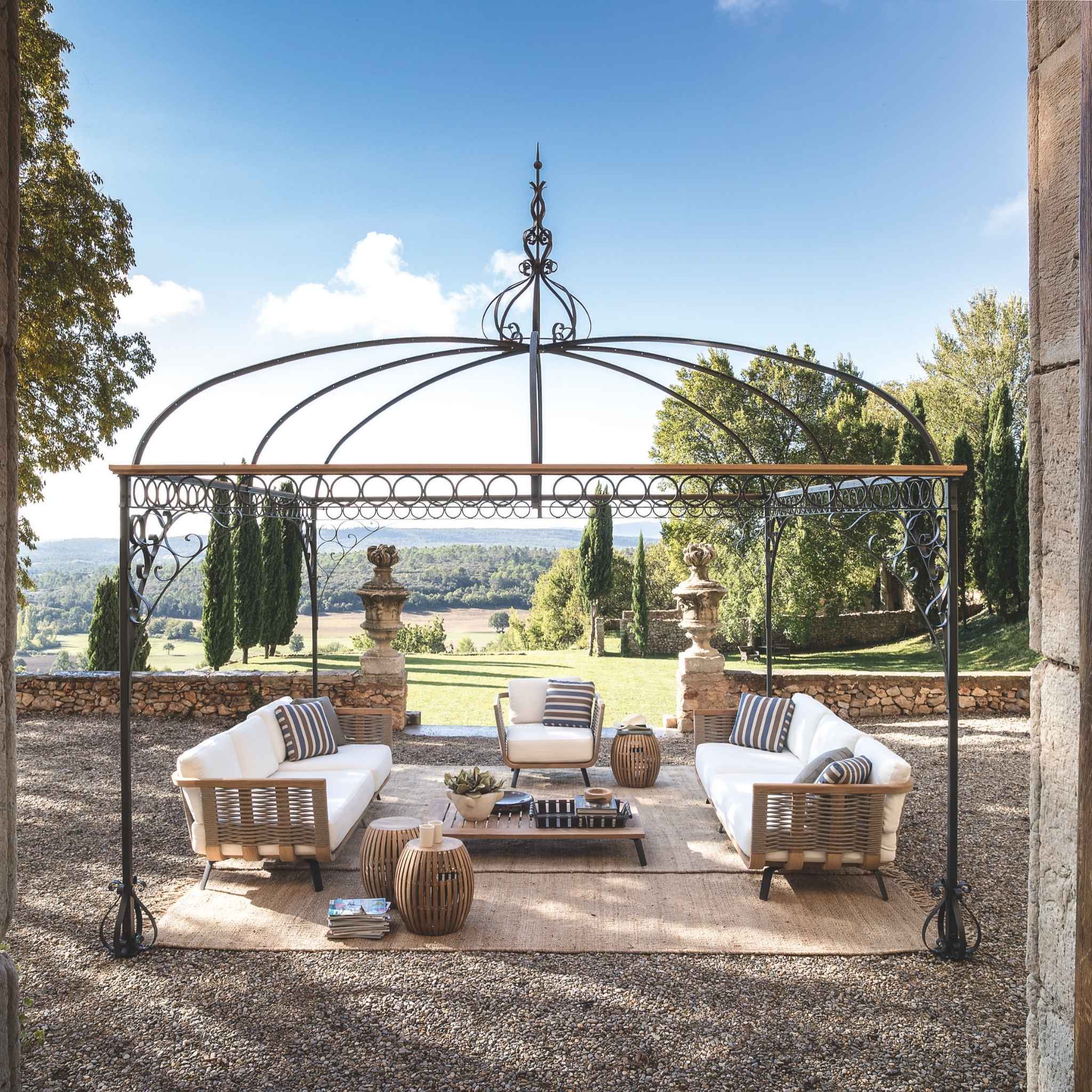 Image of Unopiu classic steel gazebo with trees and Italian countryside in the background