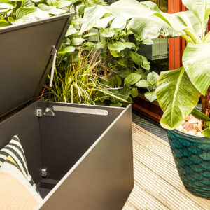 Image of opened El Pecho outdoor storage box, showing stainless steel vent and rungs on bottom of the cushion box, which increase air circulation within