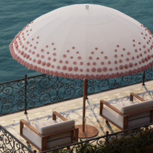 Image of Tuuci Image of the hand-made blossoms on the canopy of Tuuci Ombré Blossom luxury parasol above Tuuci Sail exterior lounge furniture