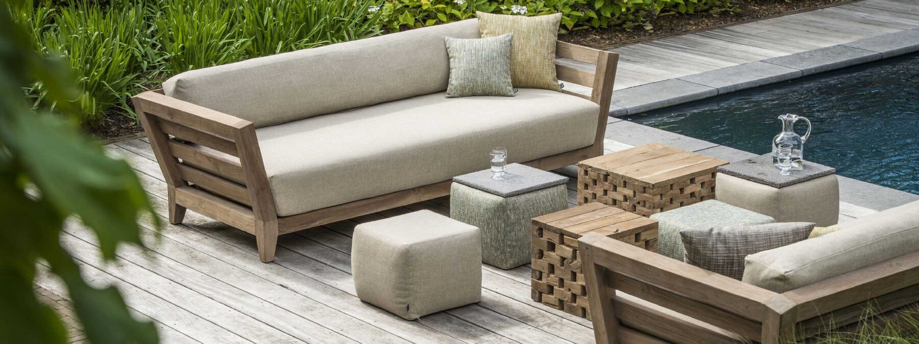 Image of pair of Mia 3 seat teak garden sofas & Puzzle teak coffee tables by Gommaire