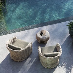 Image of pair of Gommaire Feline easy chairs and Root Ball low table on sunny poolside