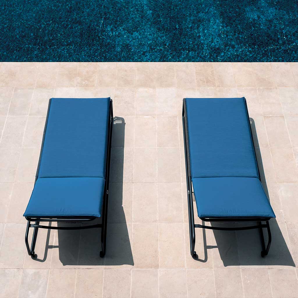 Image of aerial view of pair of Harp black sun loungers with blue cushions, shown on sunny poolside