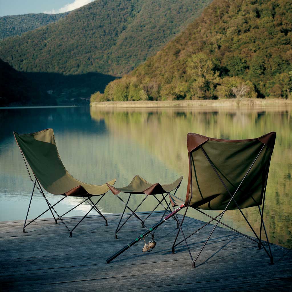 Image of pair of green-coloured Lawrence folding garden chairs on decking overlooking Italian lake.