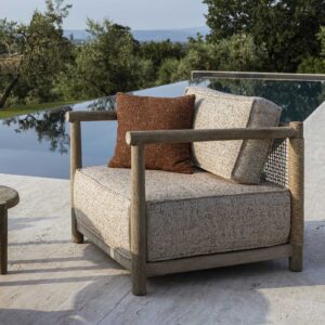 Image of Gommaire Mieke luxury garden lounge chair on decking with still water in the background