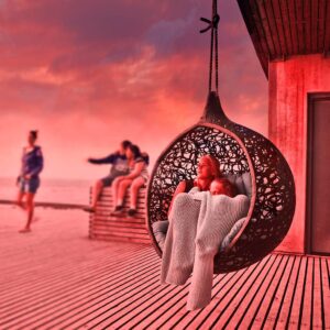 Image of Bios Mini swing chair by Unknown Nordic shown on wooden decking